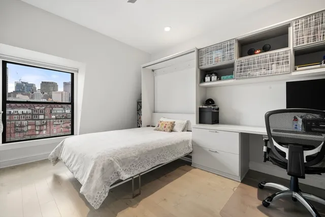 a bedroom with a bed a desk and chair