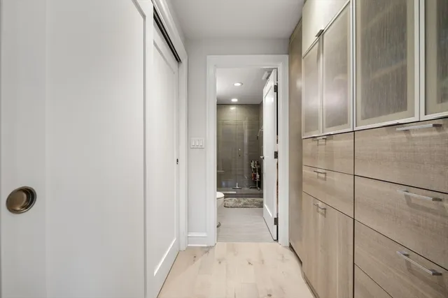 a bathroom with a double vanity sink a toilet and shower