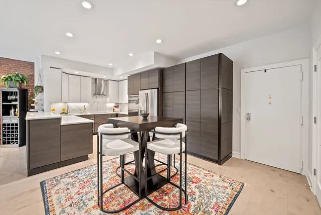 a kitchen with stainless steel appliances granite countertop a refrigerator and a stove top oven