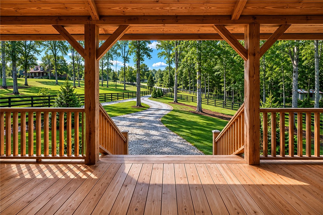 414 Devon Way Anderson, SC 29621 - Photo 3 of 50 A winding gravel driveway through verdant lawns leads to a serene rural retreat.
