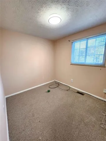a bathroom with a granite countertop tub sink and mirror