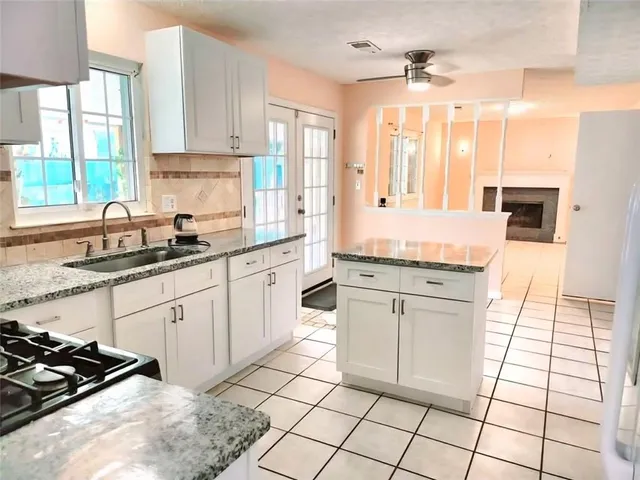 a kitchen with a stove a sink and a refrigerator