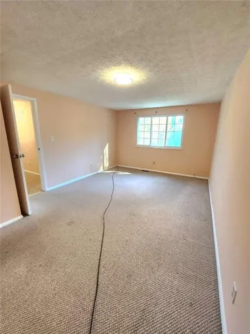 an empty room with a empty space and windows