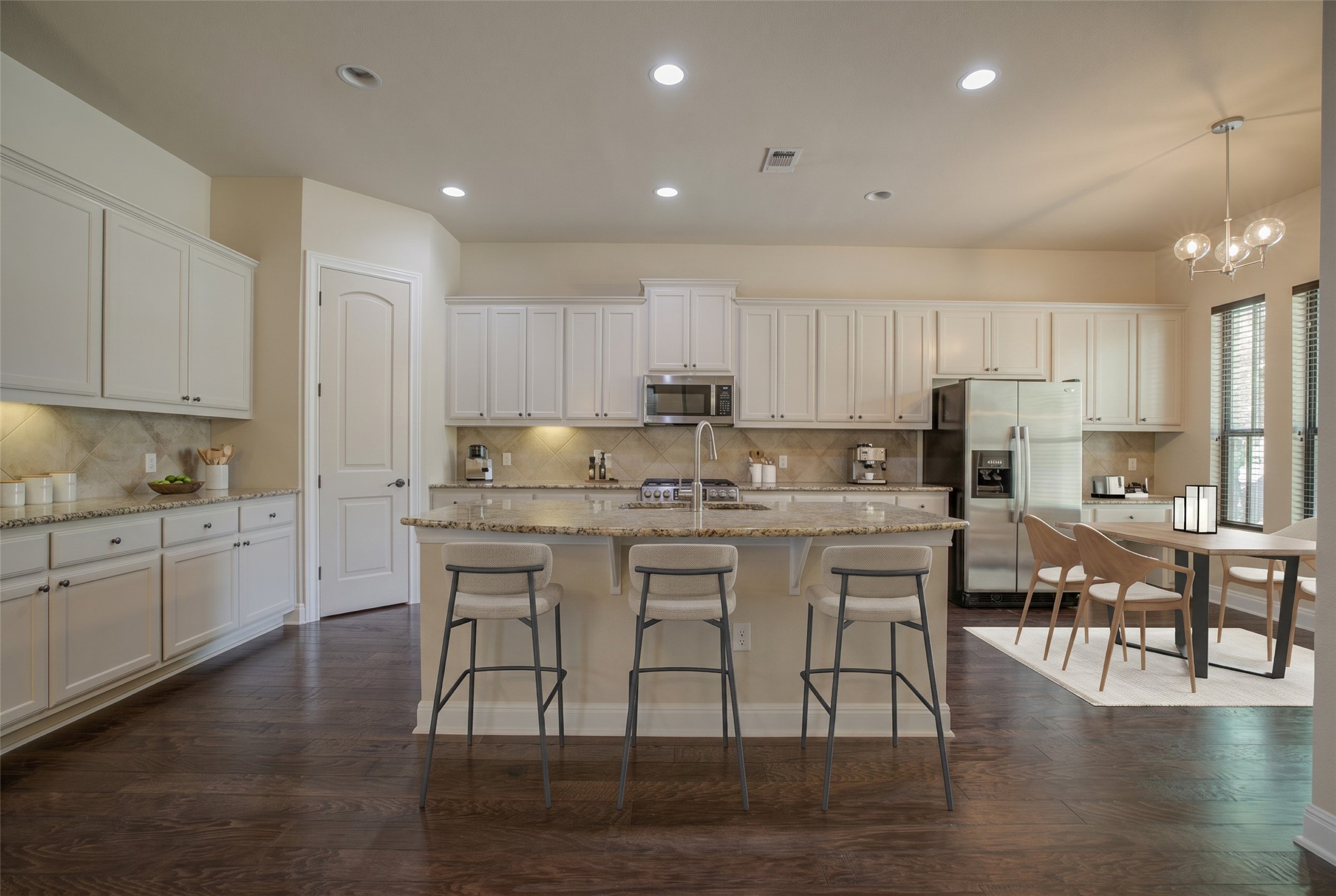 4524 Berkman Drive Austin, TX 78723 - Photo 3 of 38 Open-concept kitchen featuring white cabinetry, light-toned countertops, and stainless-steel appliances