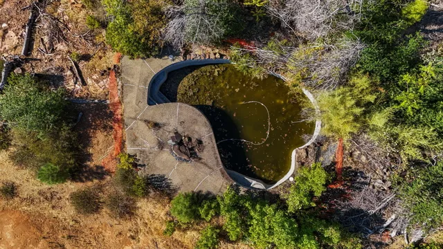 an aerial view of a house with a yard and trees