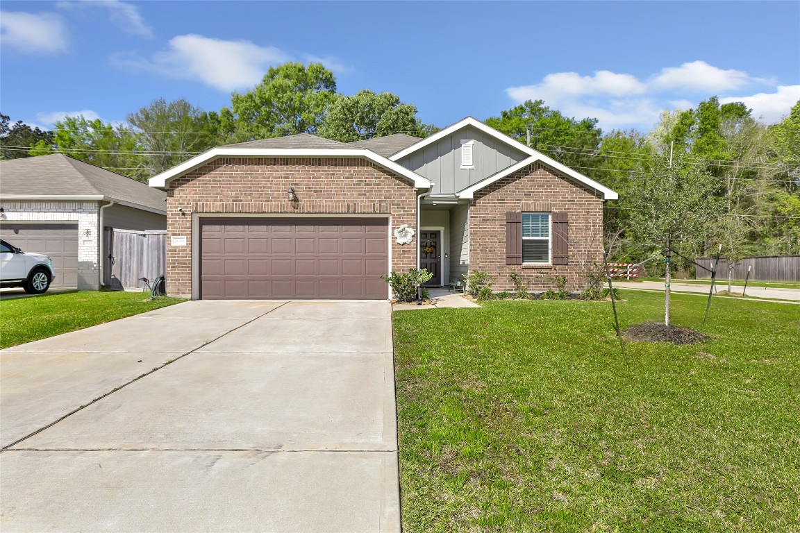 28319 Peppard Lane Huffman, TX 77336 - Photo 1 of 30 a front view of a house with a yard and garage