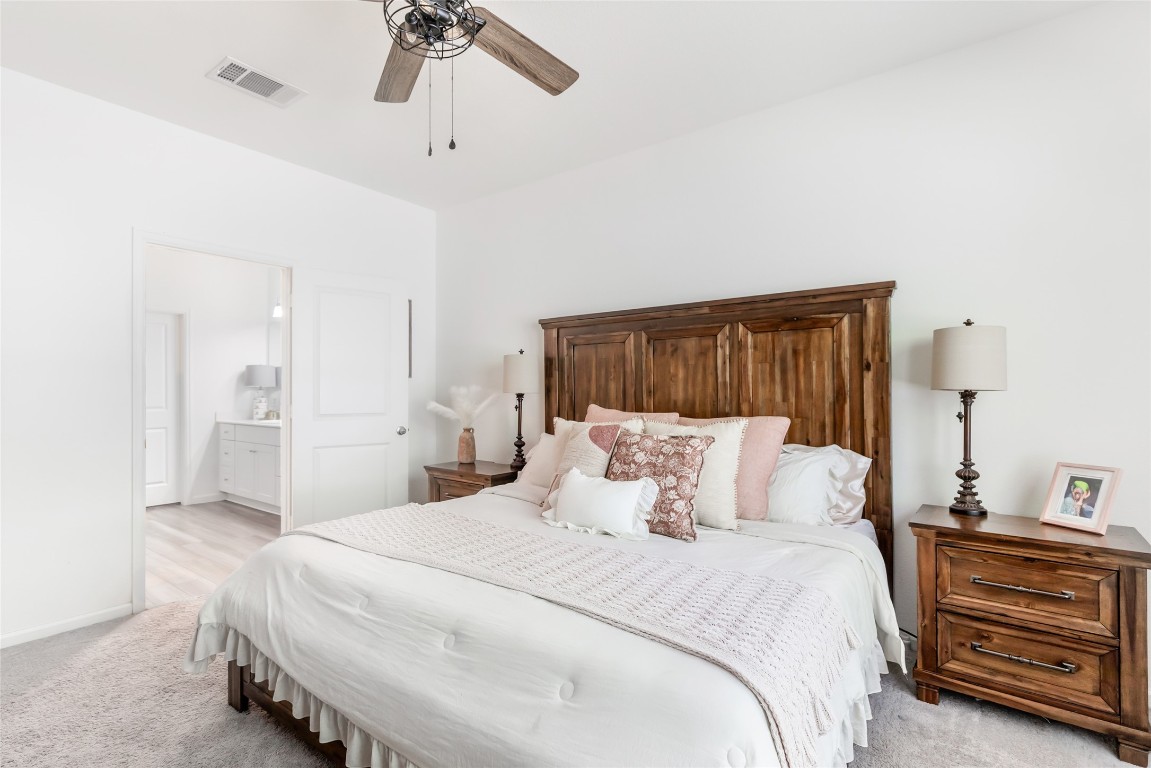28319 Peppard Lane Huffman, TX 77336 - Photo 18 of 30 a bedroom with a bed and a chandelier