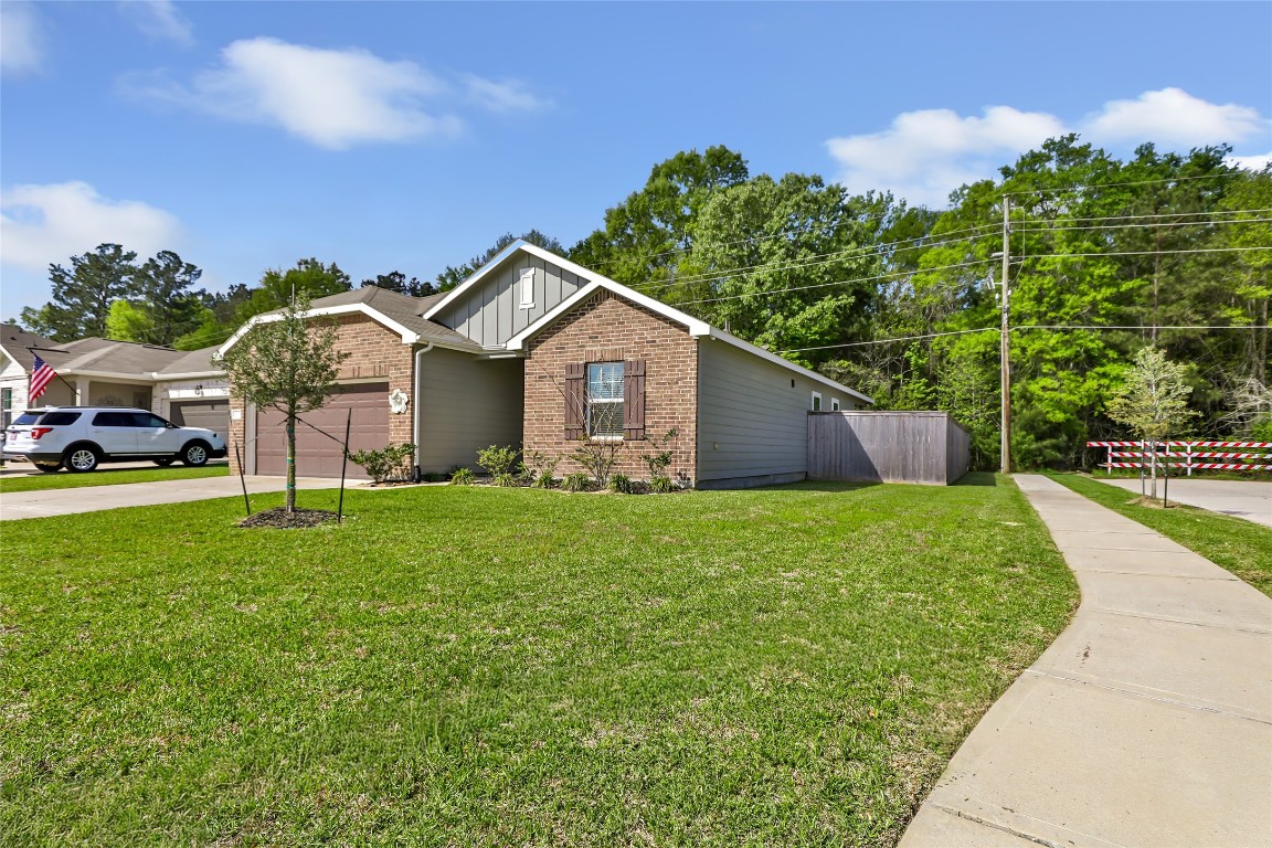 28319 Peppard Lane Huffman, TX 77336 - Photo 26 of 30 a front view of a house with a garden