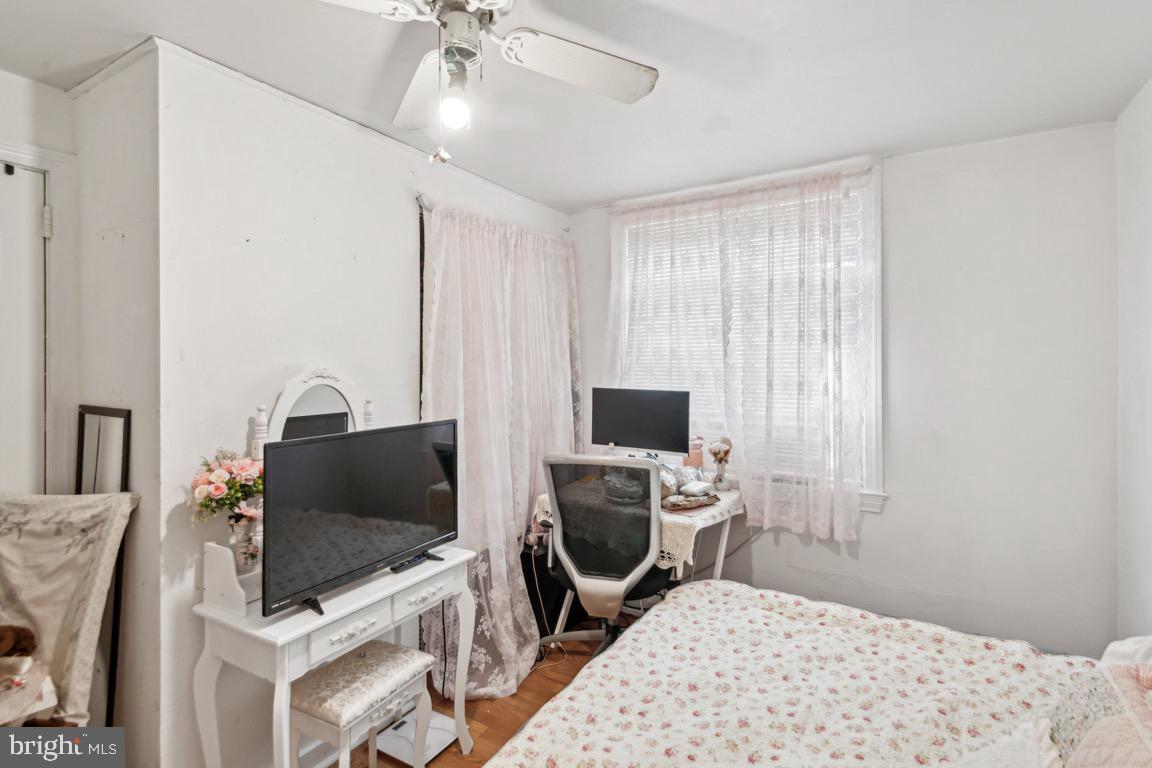 603 Raritan Street Camden, NJ 08105 - Photo 7 of 9 a bedroom with a bed and a flat screen tv
