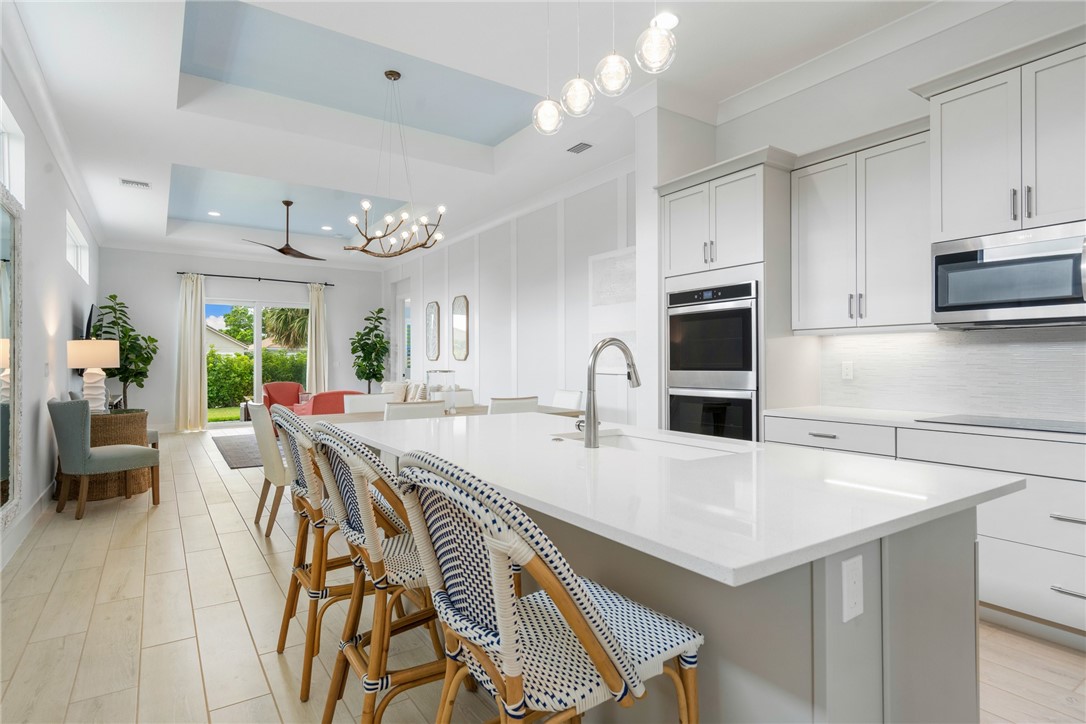 2159 Falls Manor Vero Beach, FL 32967 - Photo 11 of 36 a large kitchen with kitchen island a large island in it