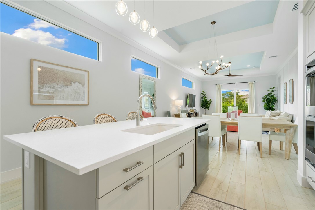 2159 Falls Manor Vero Beach, FL 32967 - Photo 15 of 36 a view of a kitchen area with furniture and wooden floor
