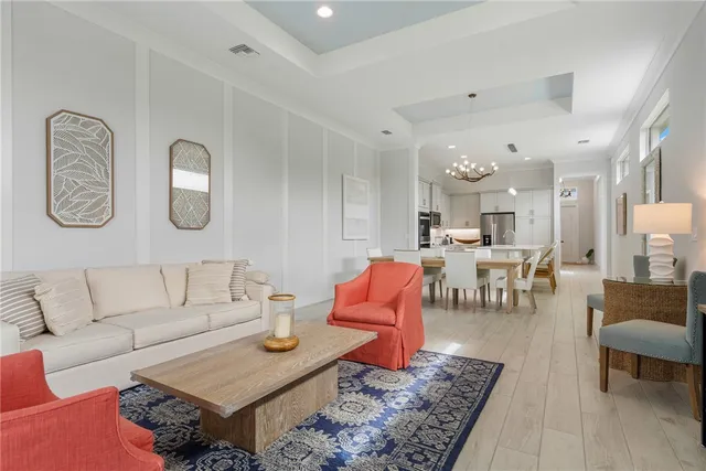 a living room with furniture kitchen view and a table