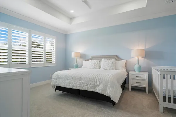 a spacious bedroom with a bed and a window