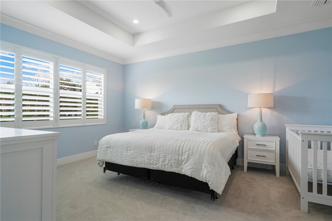 2159 Falls Manor Vero Beach, FL 32967 - Photo 24 of 36 a spacious bedroom with a bed and a window