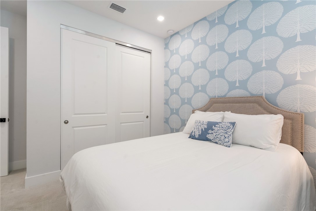 2159 Falls Manor Vero Beach, FL 32967 - Photo 27 of 36 a bedroom with a bed and a shower curtain