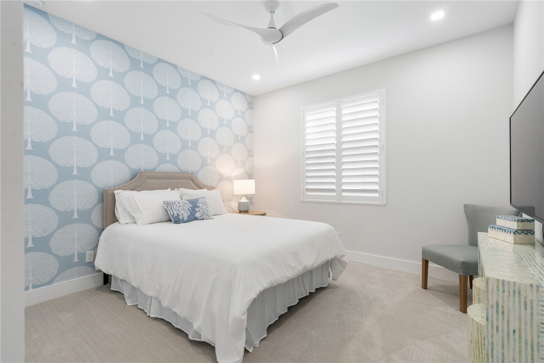 2159 Falls Manor Vero Beach, FL 32967 - Photo 29 of 36 a bedroom with a bed and a lamp