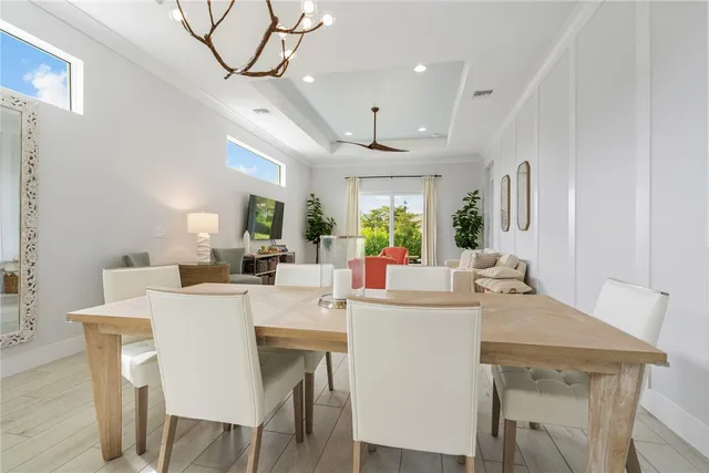a dining room with a table chairs and a kitchen
