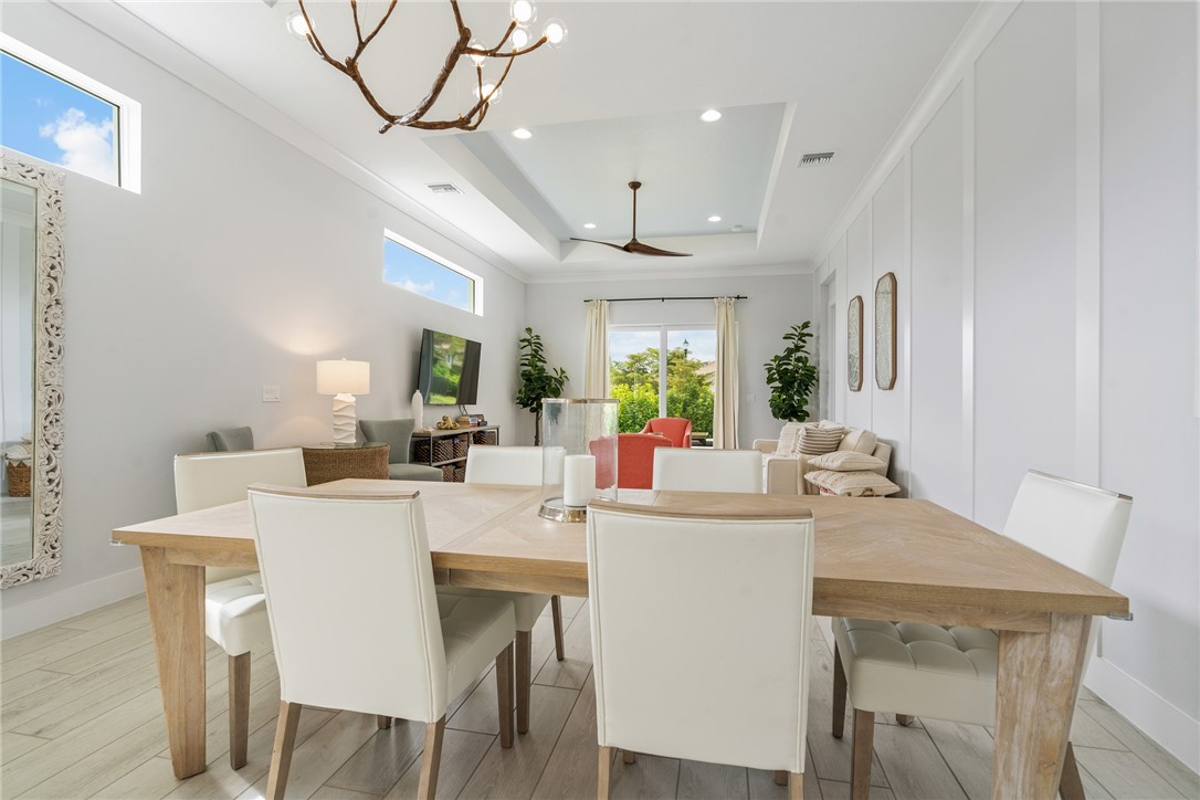 2159 Falls Manor Vero Beach, FL 32967 - Photo 3 of 36 a dining room with a table chairs and a kitchen