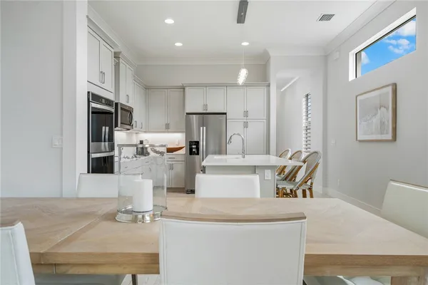 a kitchen with kitchen island a stove a sink and a refrigerator