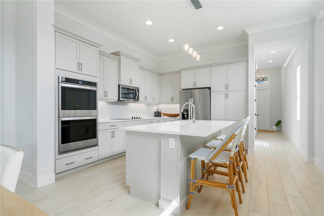 2159 Falls Manor Vero Beach, FL 32967 - Photo 10 of 36 a kitchen with a sink a microwave and refrigerator