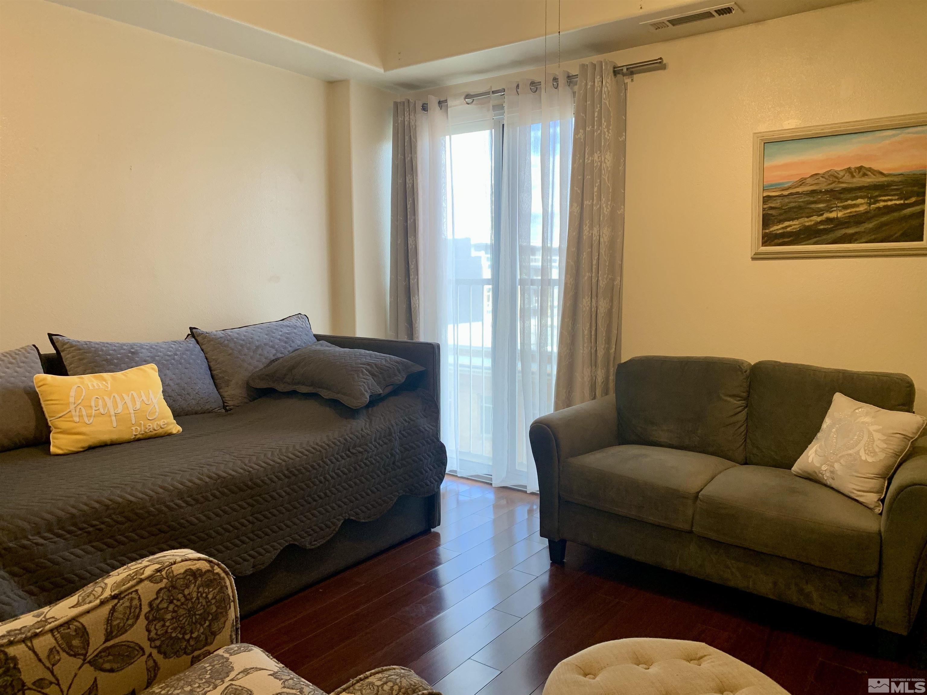 200 West 2nd Street, Unit 404 Reno, NV 89501 - Photo 3 of 30 a living room with a couch and a window