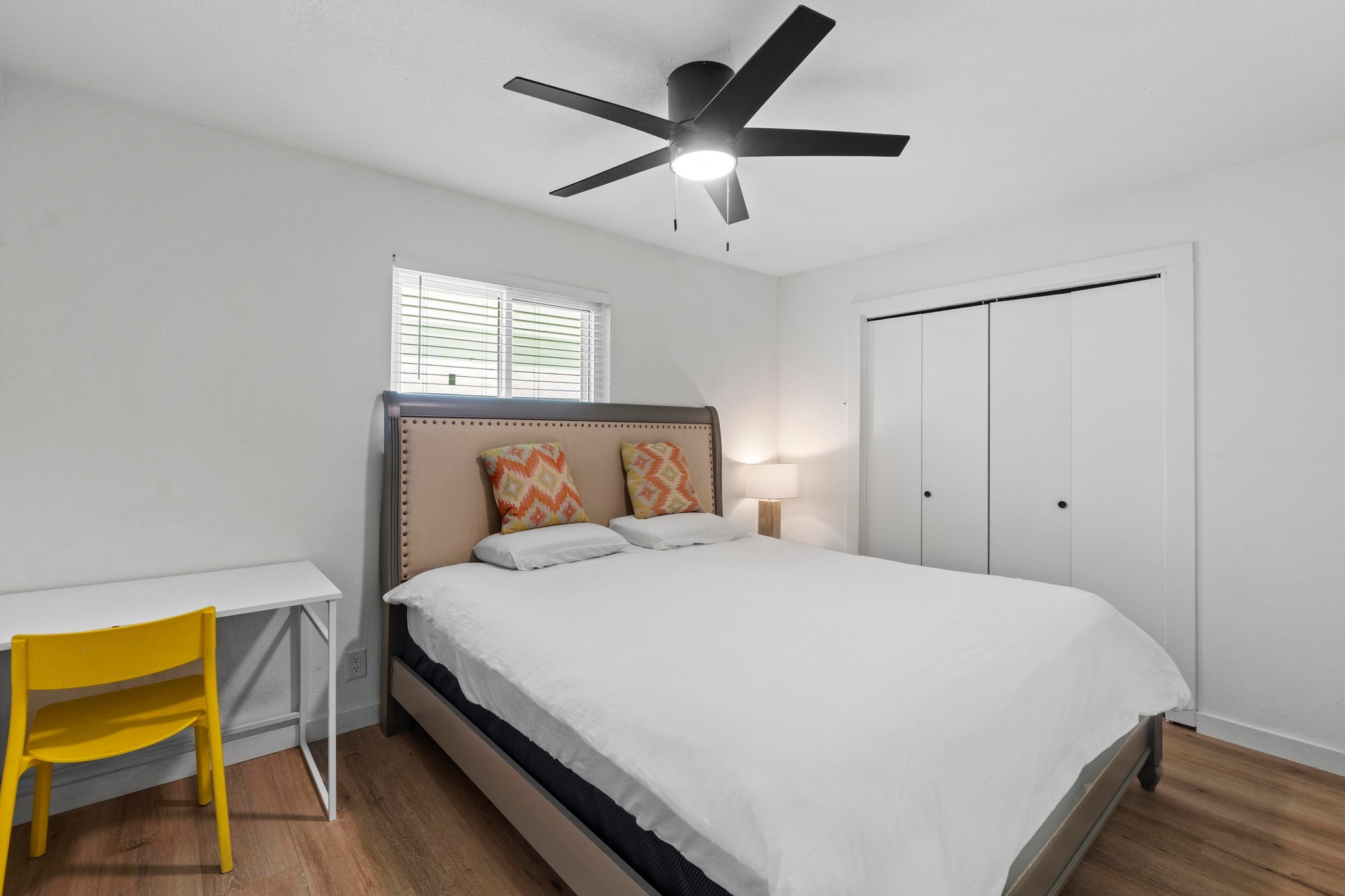 10601 Macmora Road, Unit B Austin, TX 78758 - Photo 12 of 22 Hardwood floors and a contemporary ceiling fan elevate the comfort of this private bedroom.