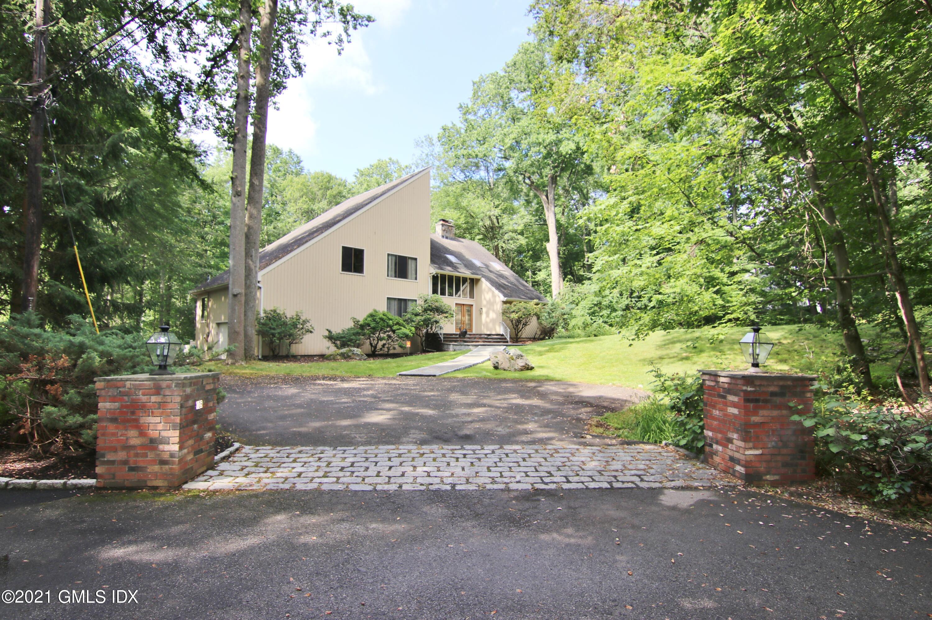 106 Gun Club Road Stamford, CT 06903 - Photo 1 of 38 a view of a yard with plants and large trees