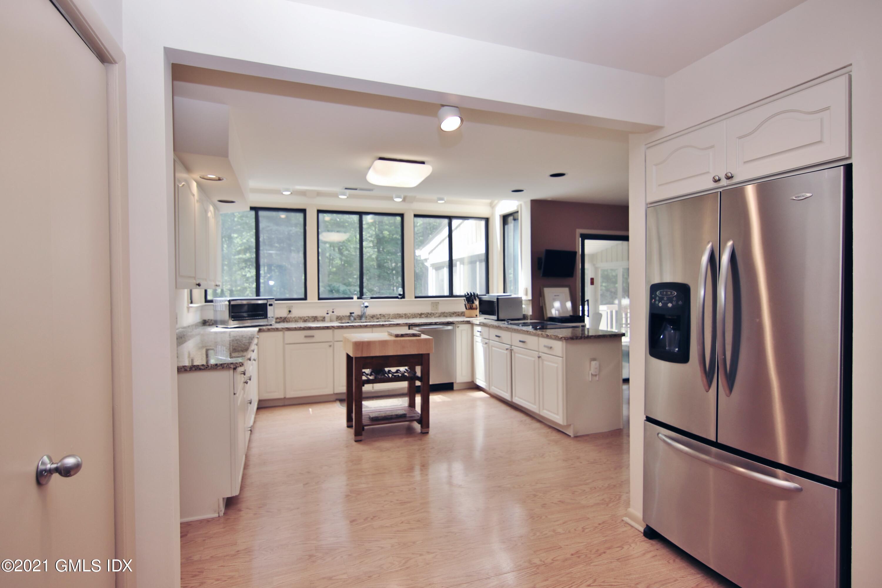 106 Gun Club Road Stamford, CT 06903 - Photo 13 of 38 a kitchen with a refrigerator and white cabinets