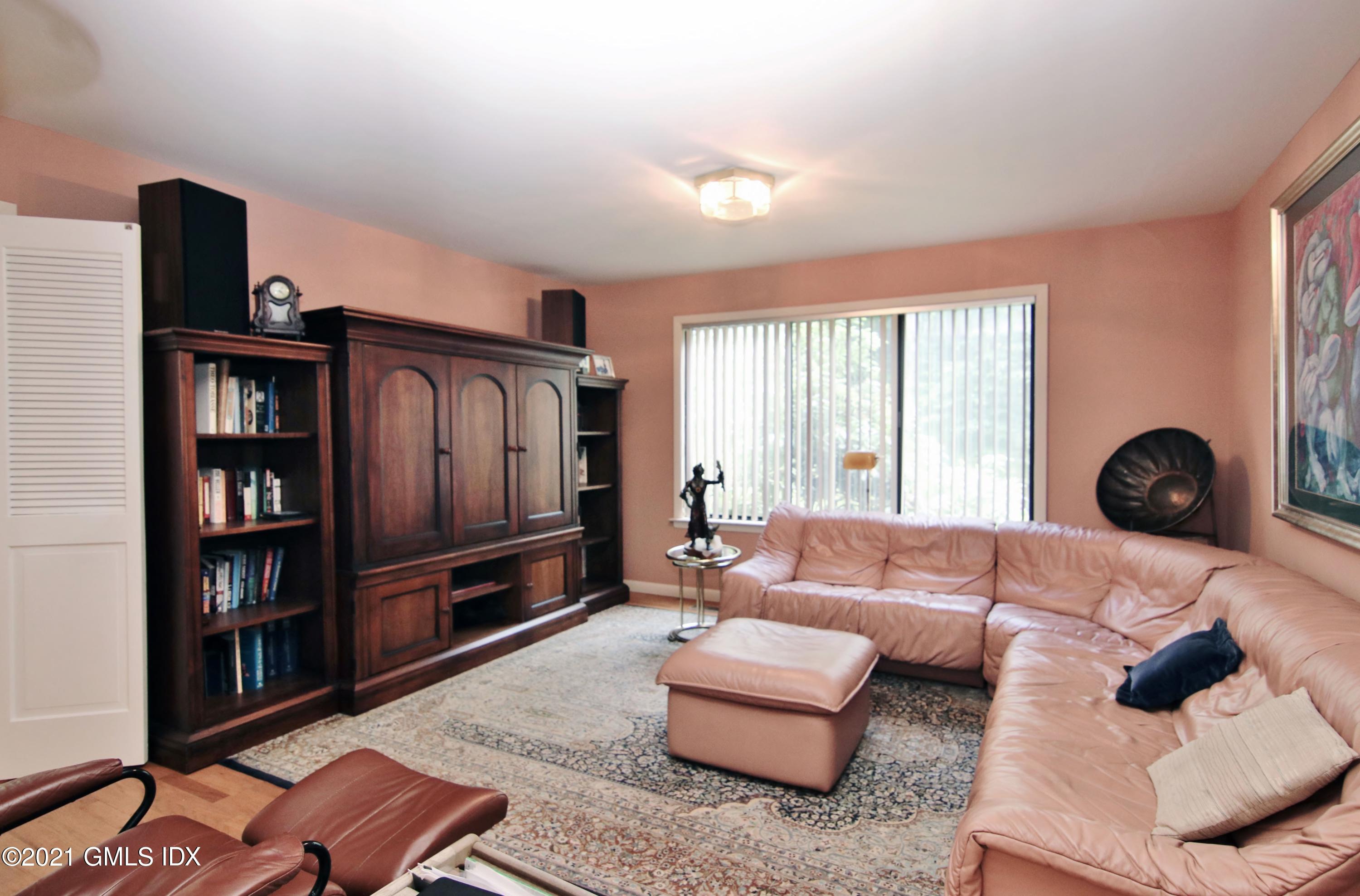 106 Gun Club Road Stamford, CT 06903 - Photo 18 of 38 a living room with furniture and a book shelf
