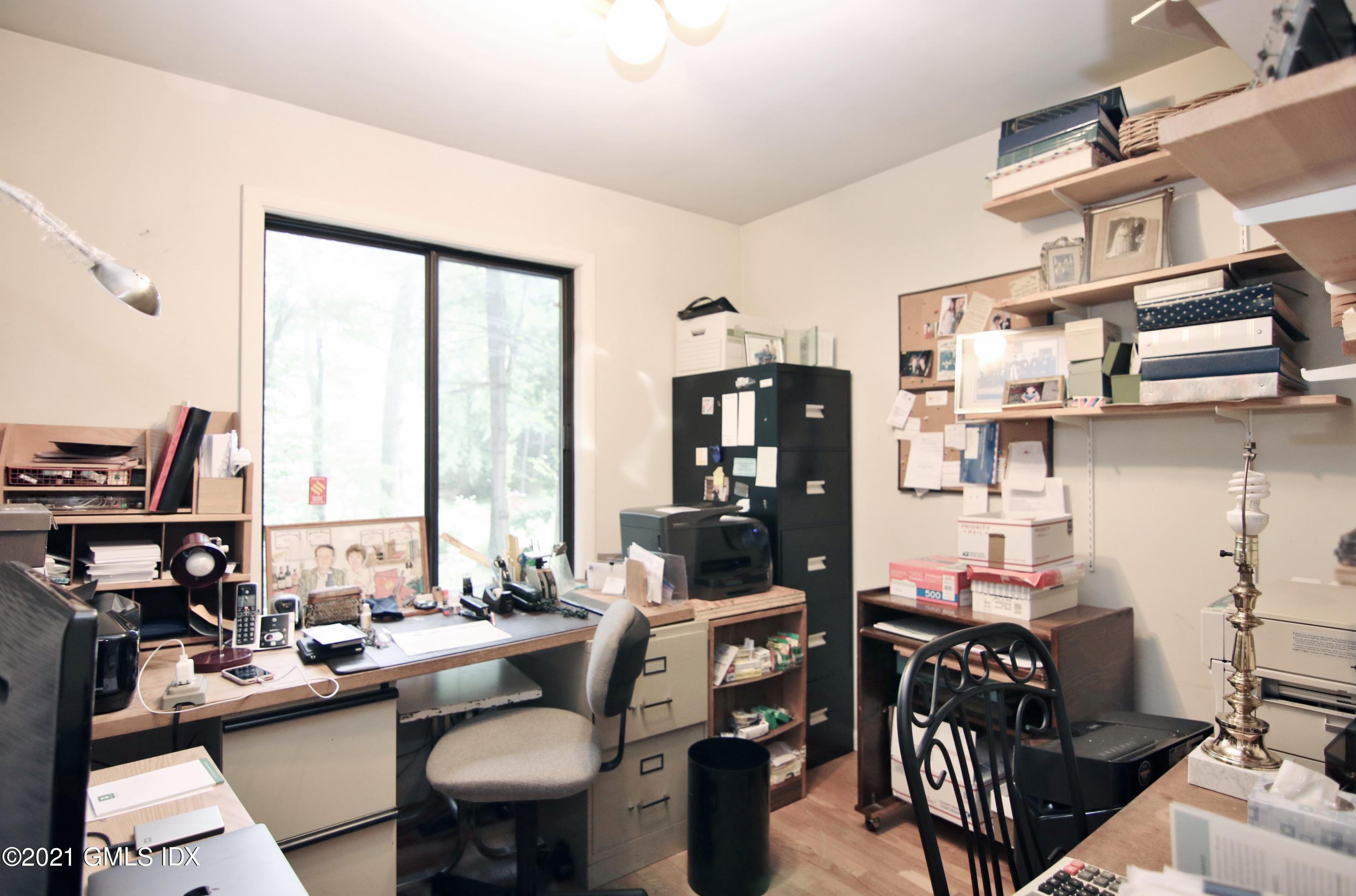 106 Gun Club Road Stamford, CT 06903 - Photo 19 of 38 a view of a workspace with furniture and a large window
