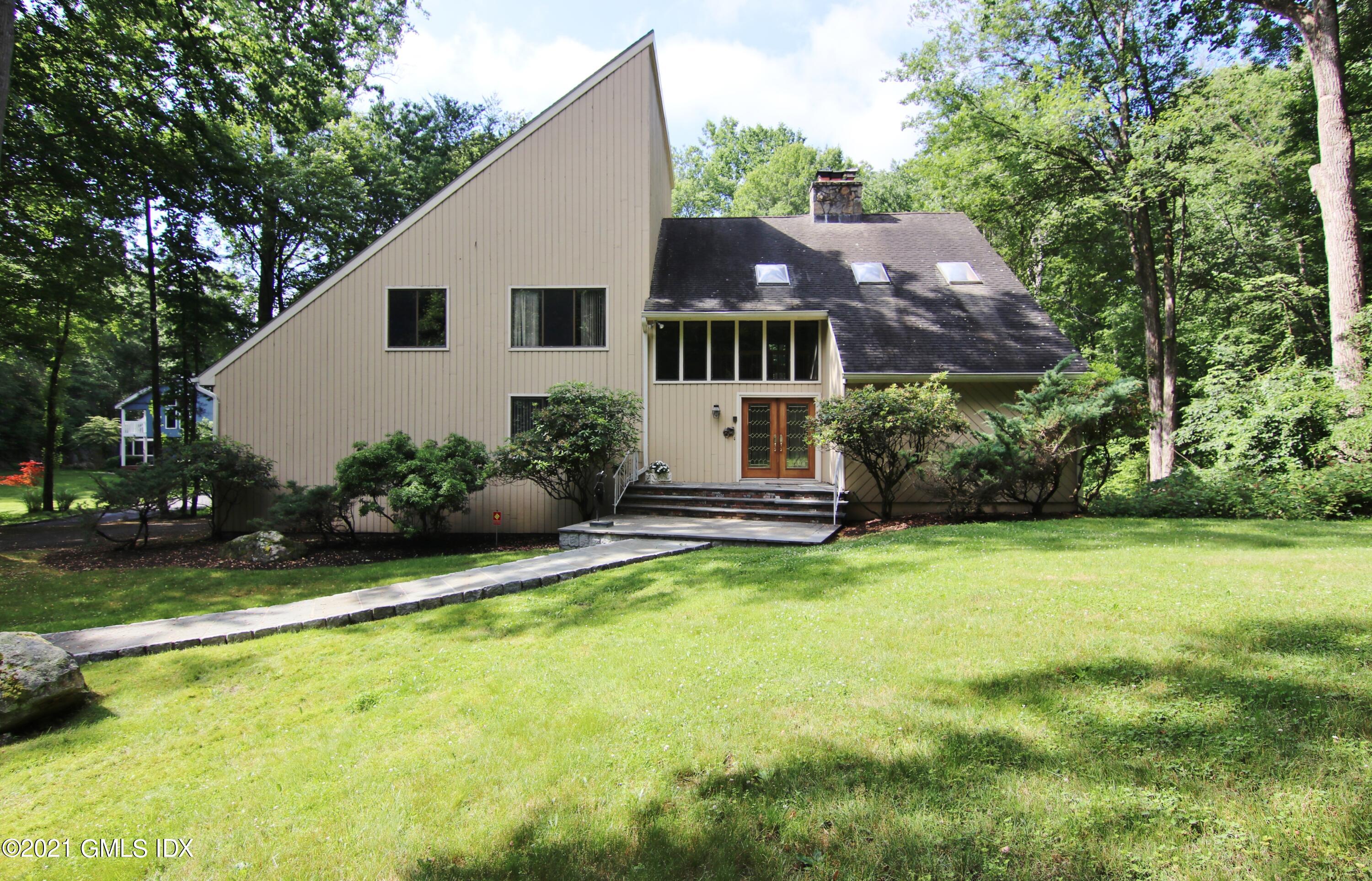 106 Gun Club Road Stamford, CT 06903 - Photo 2 of 38 a view of a house with a yard and sitting area