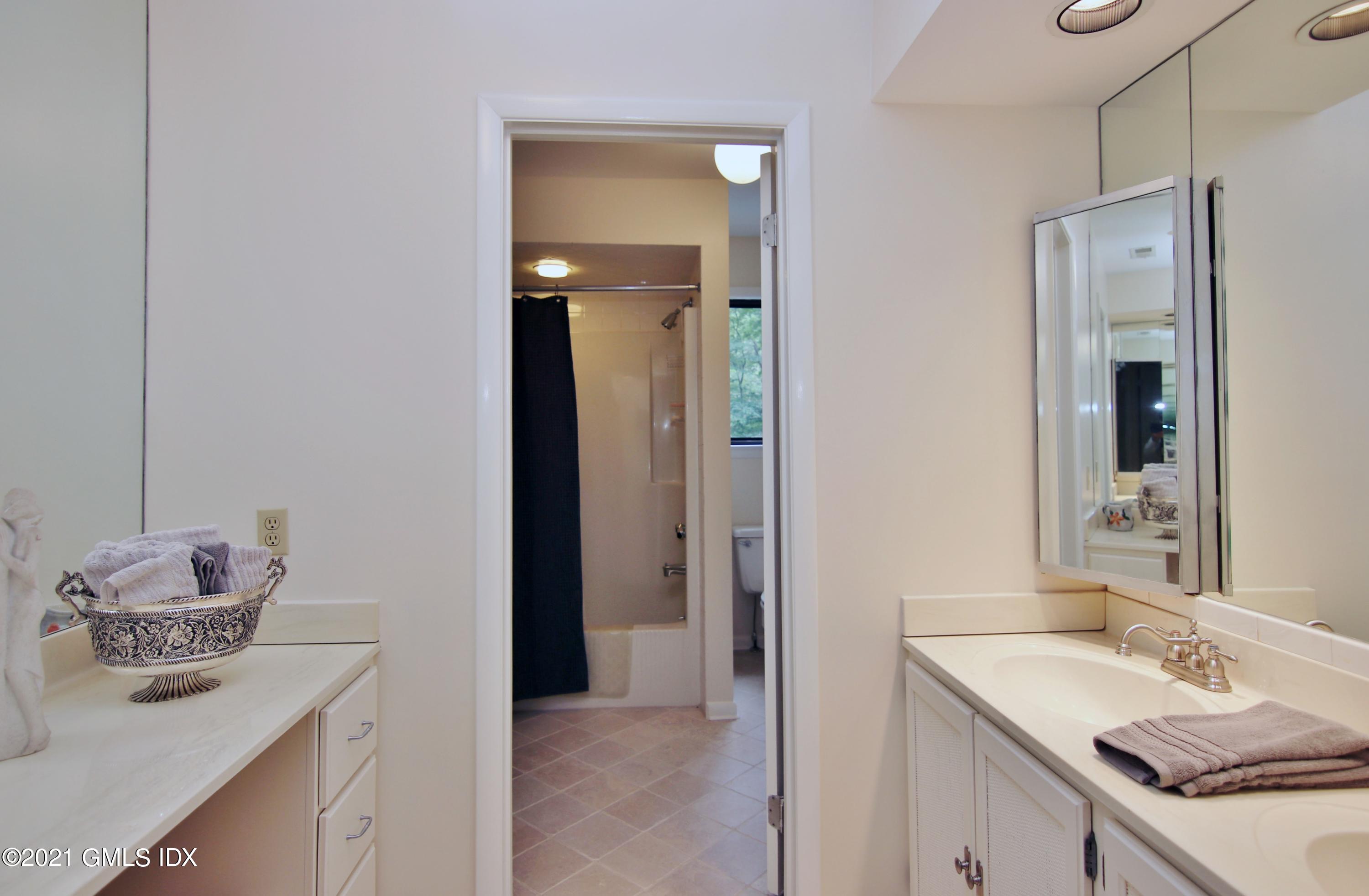 106 Gun Club Road Stamford, CT 06903 - Photo 25 of 38 a bathroom with a granite countertop sink and a mirror