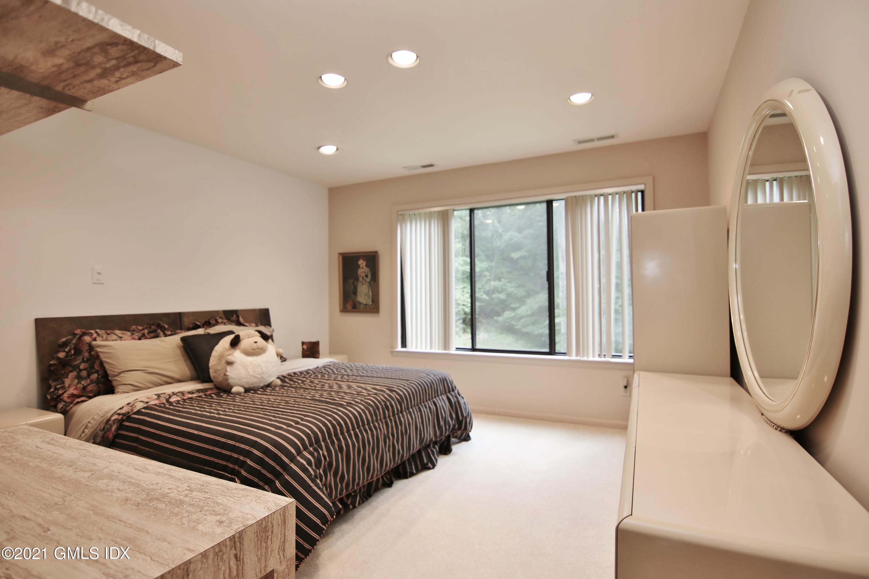 106 Gun Club Road Stamford, CT 06903 - Photo 26 of 38 a bedroom with a large bed and a large window