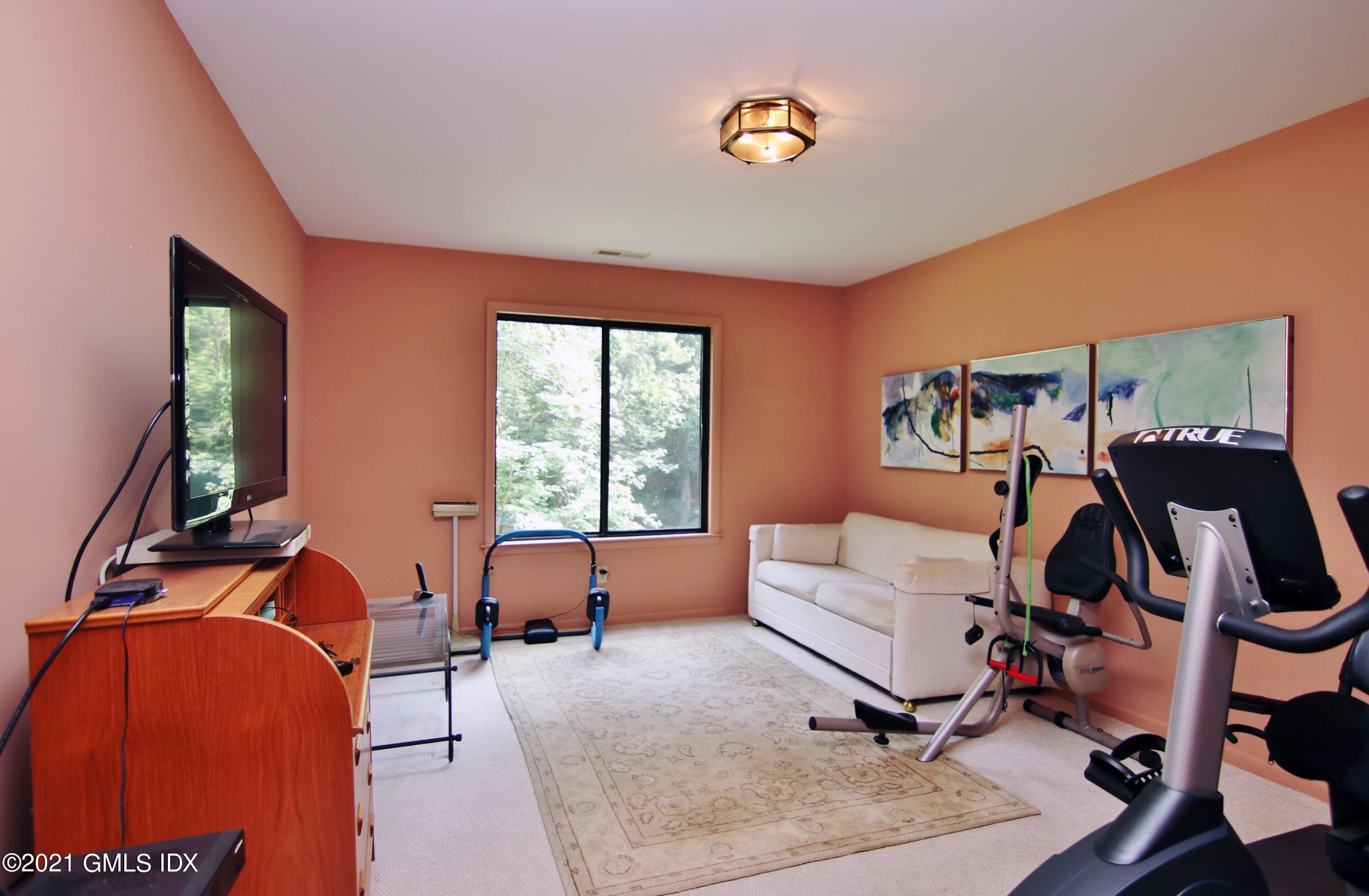 106 Gun Club Road Stamford, CT 06903 - Photo 27 of 38 a living room with furniture and a flat screen tv