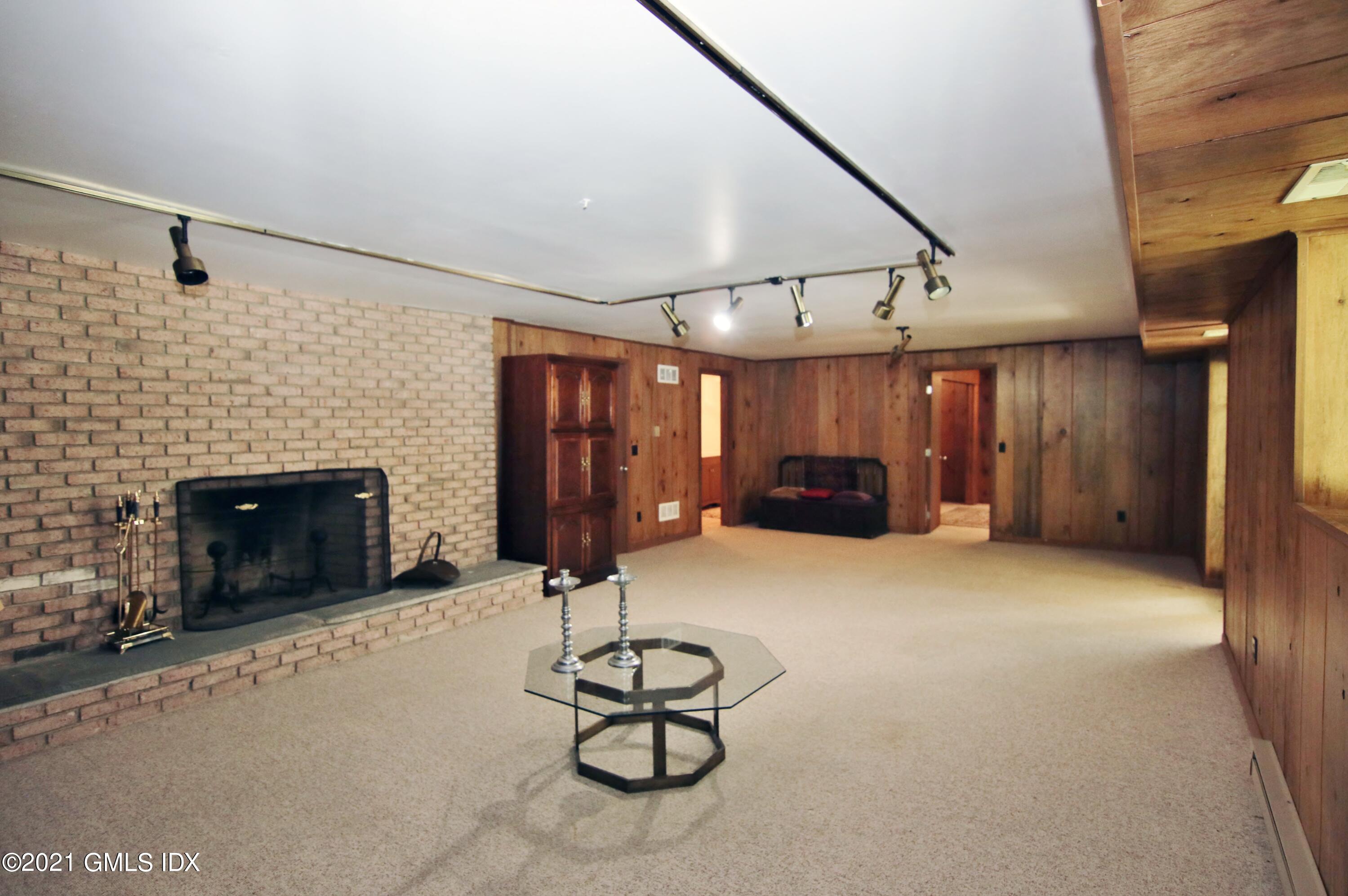 106 Gun Club Road Stamford, CT 06903 - Photo 29 of 38 a room with furniture and a fireplace