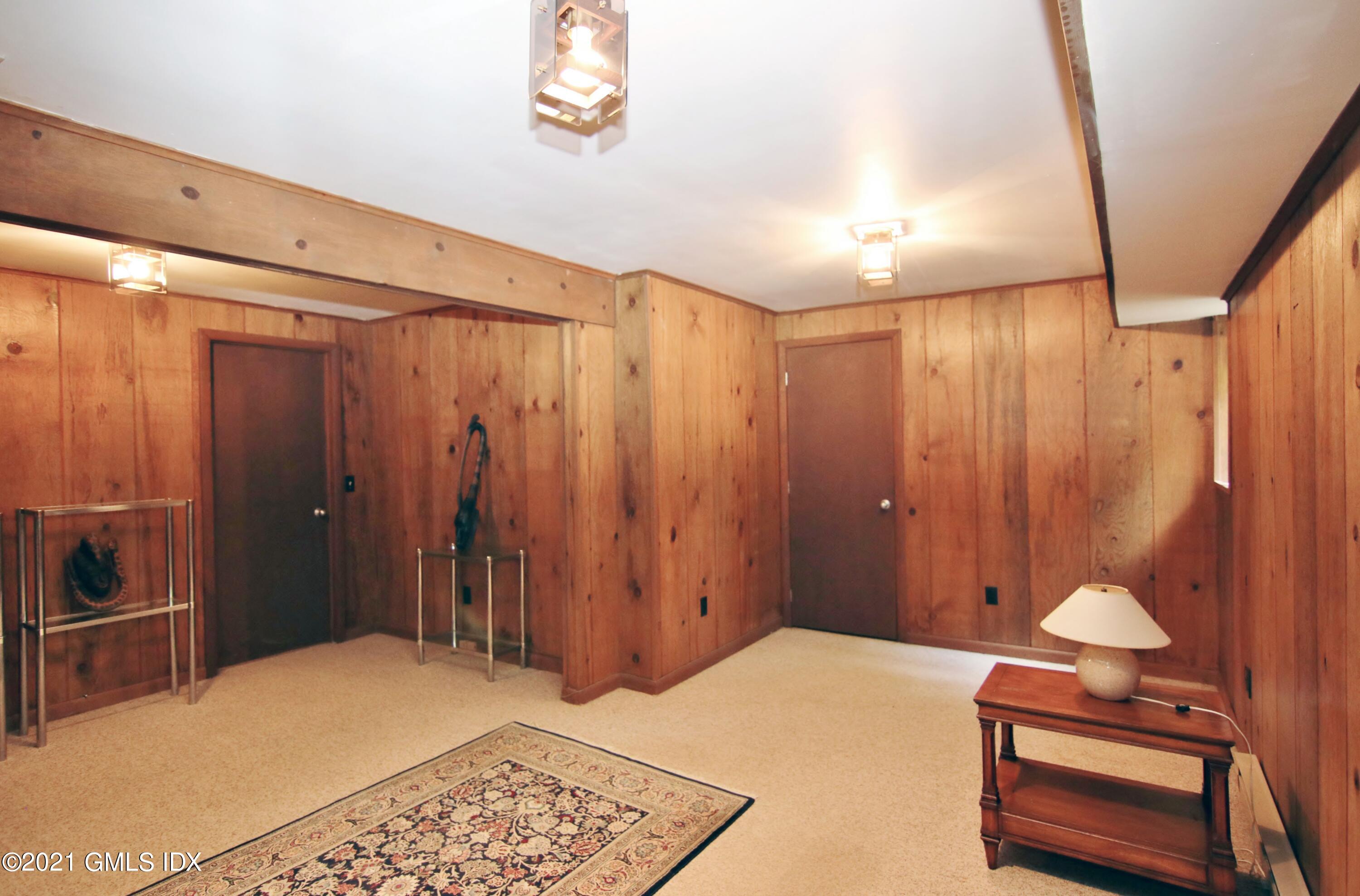 106 Gun Club Road Stamford, CT 06903 - Photo 31 of 38 a bedroom with a bed and a chandelier