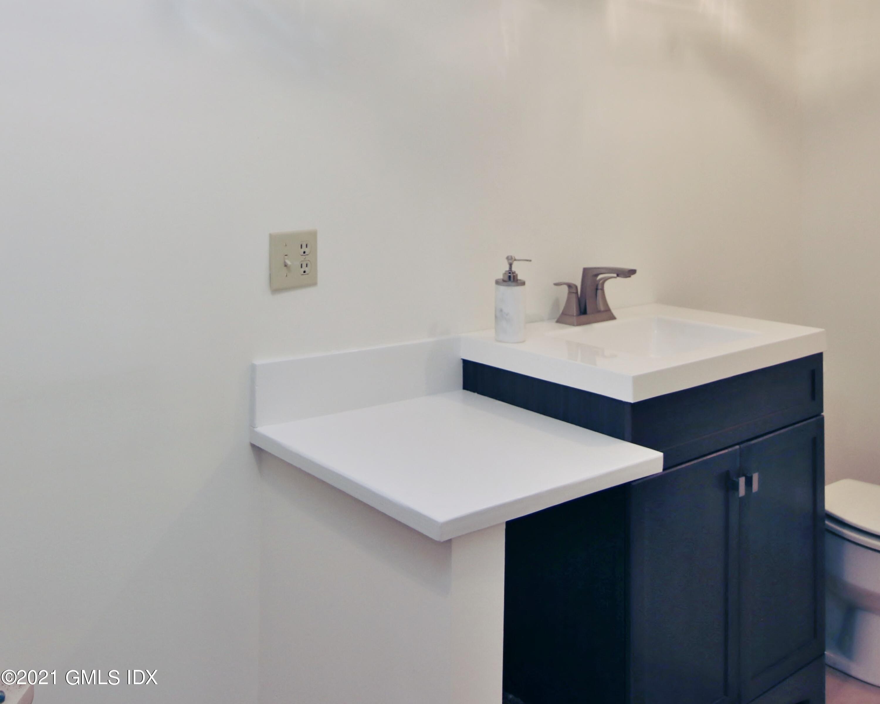 106 Gun Club Road Stamford, CT 06903 - Photo 32 of 38 a white bath tub sitting next to a white sink