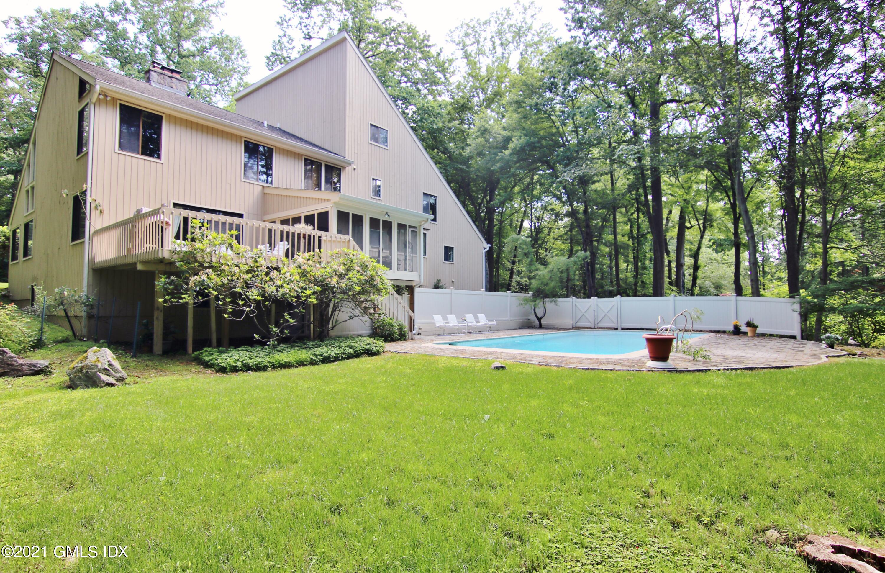 106 Gun Club Road Stamford, CT 06903 - Photo 33 of 38 a view of a house with a yard patio and sitting area