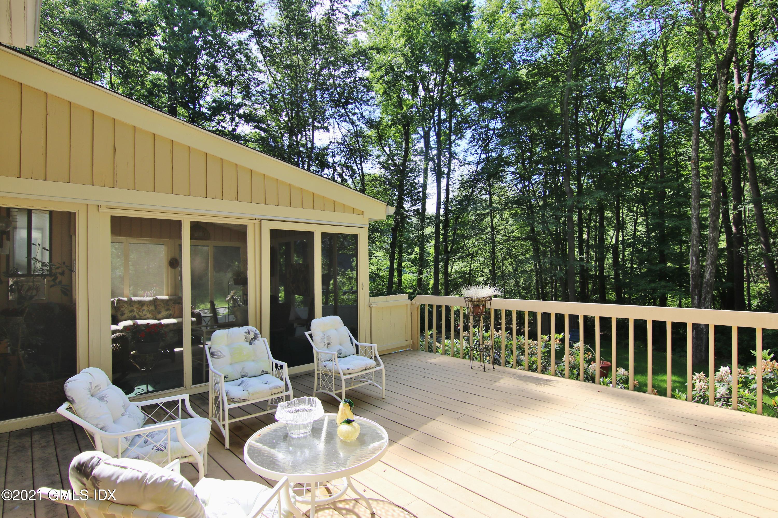 106 Gun Club Road Stamford, CT 06903 - Photo 35 of 38 a patio with glass top table and chairs