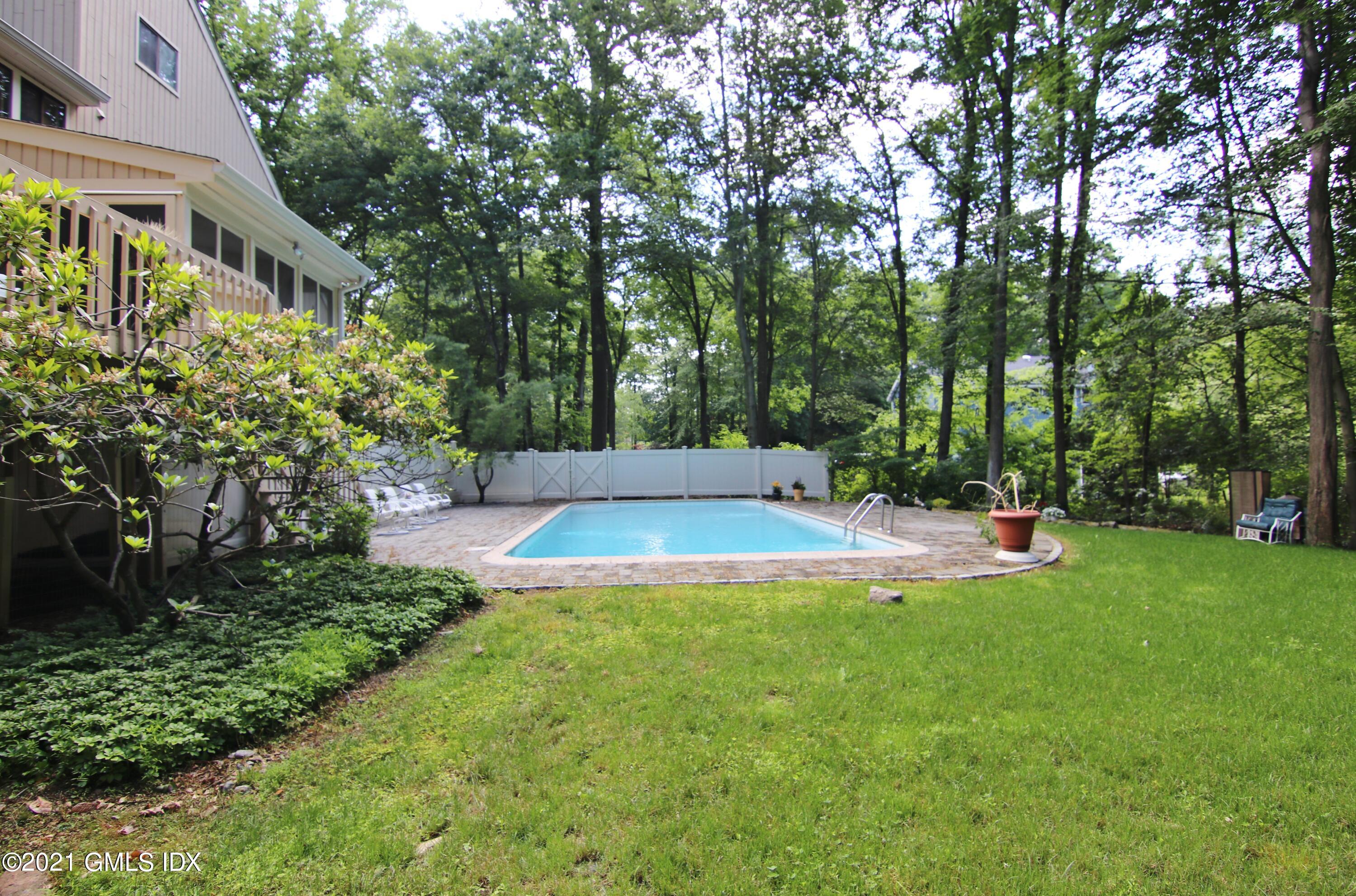 106 Gun Club Road Stamford, CT 06903 - Photo 38 of 38 a view of a backyard with a garden and trees