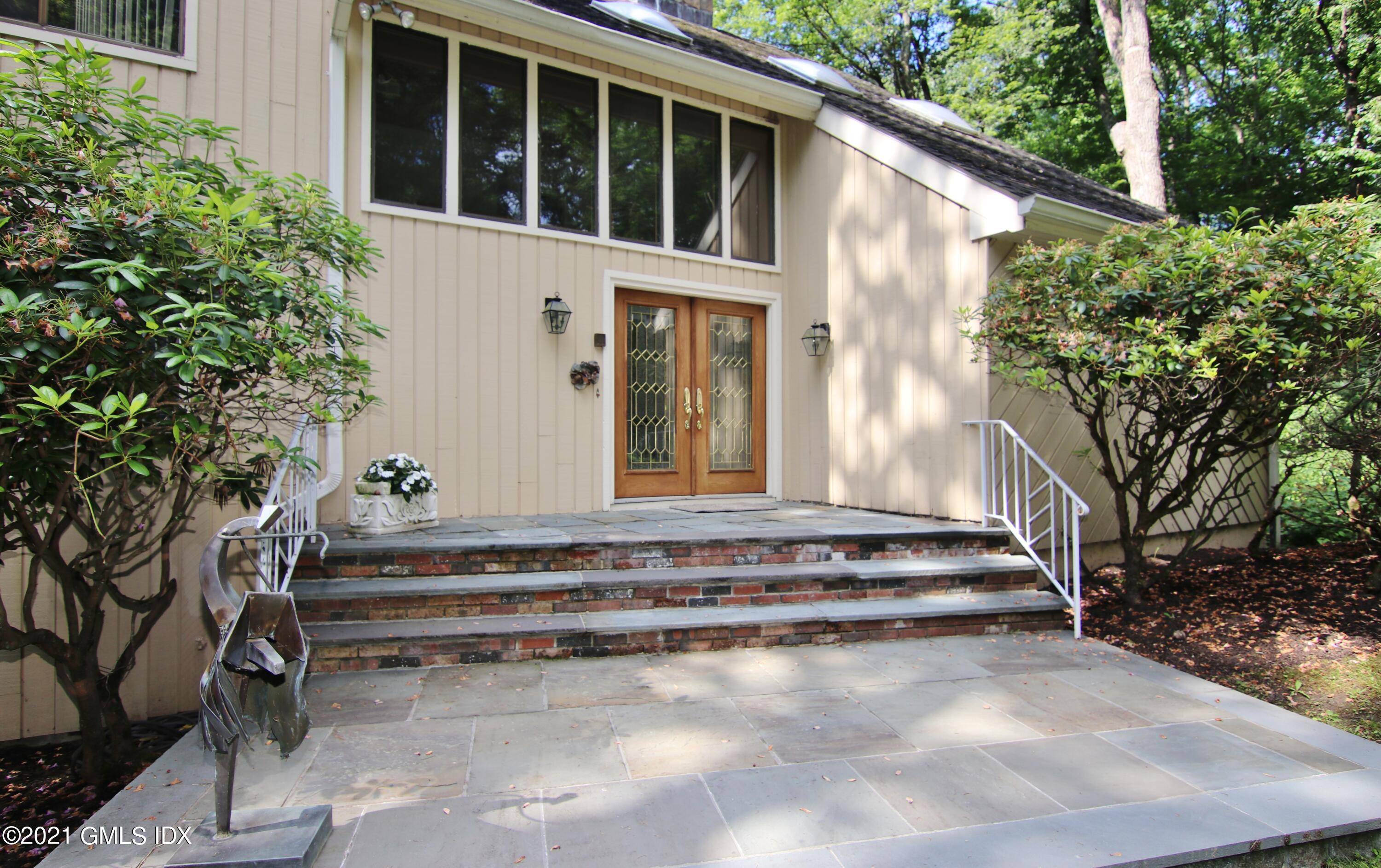 106 Gun Club Road Stamford, CT 06903 - Photo 4 of 38 a view of a house with a backyard and trees