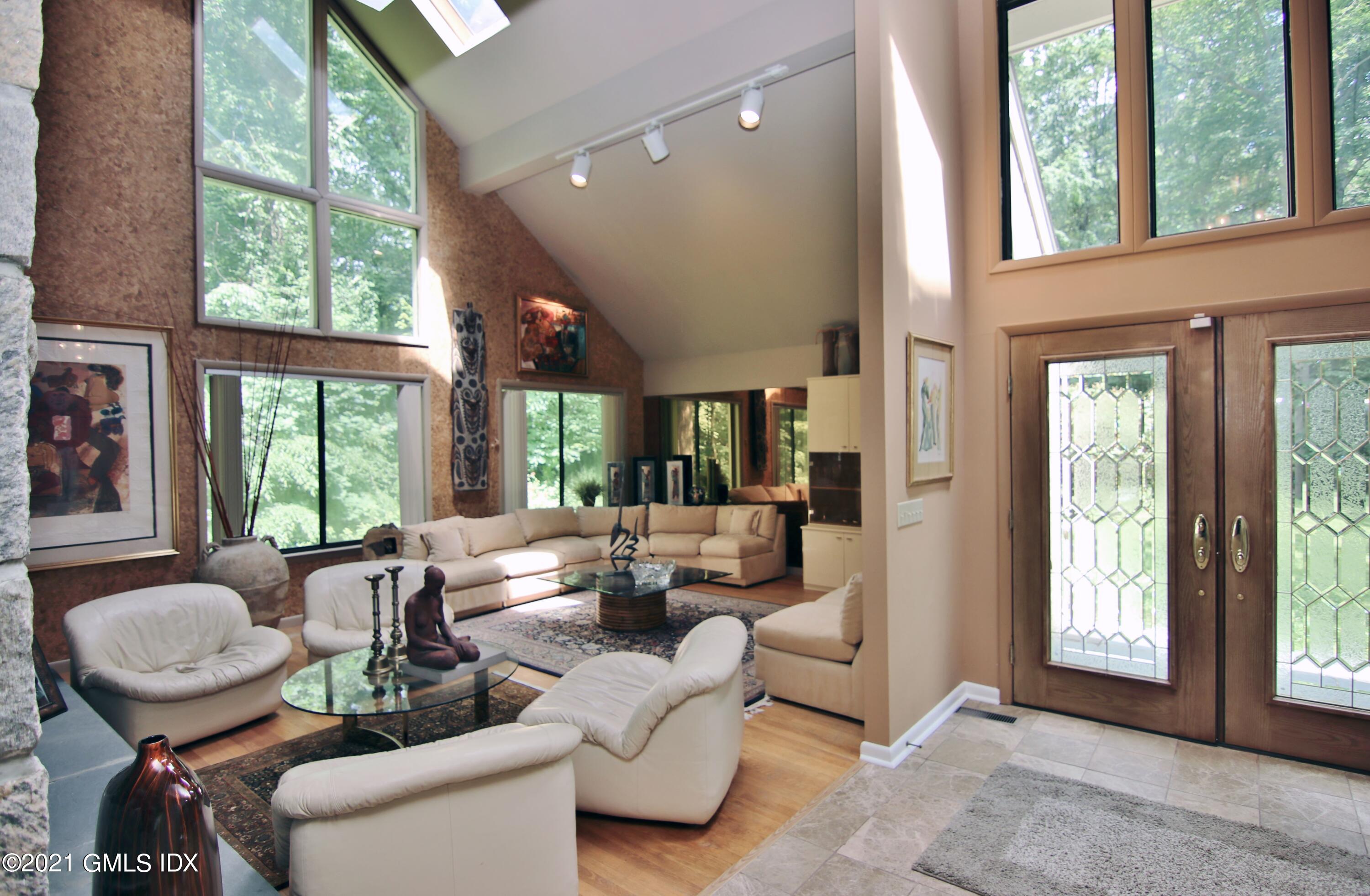 106 Gun Club Road Stamford, CT 06903 - Photo 6 of 38 a living room with furniture and a floor to ceiling window