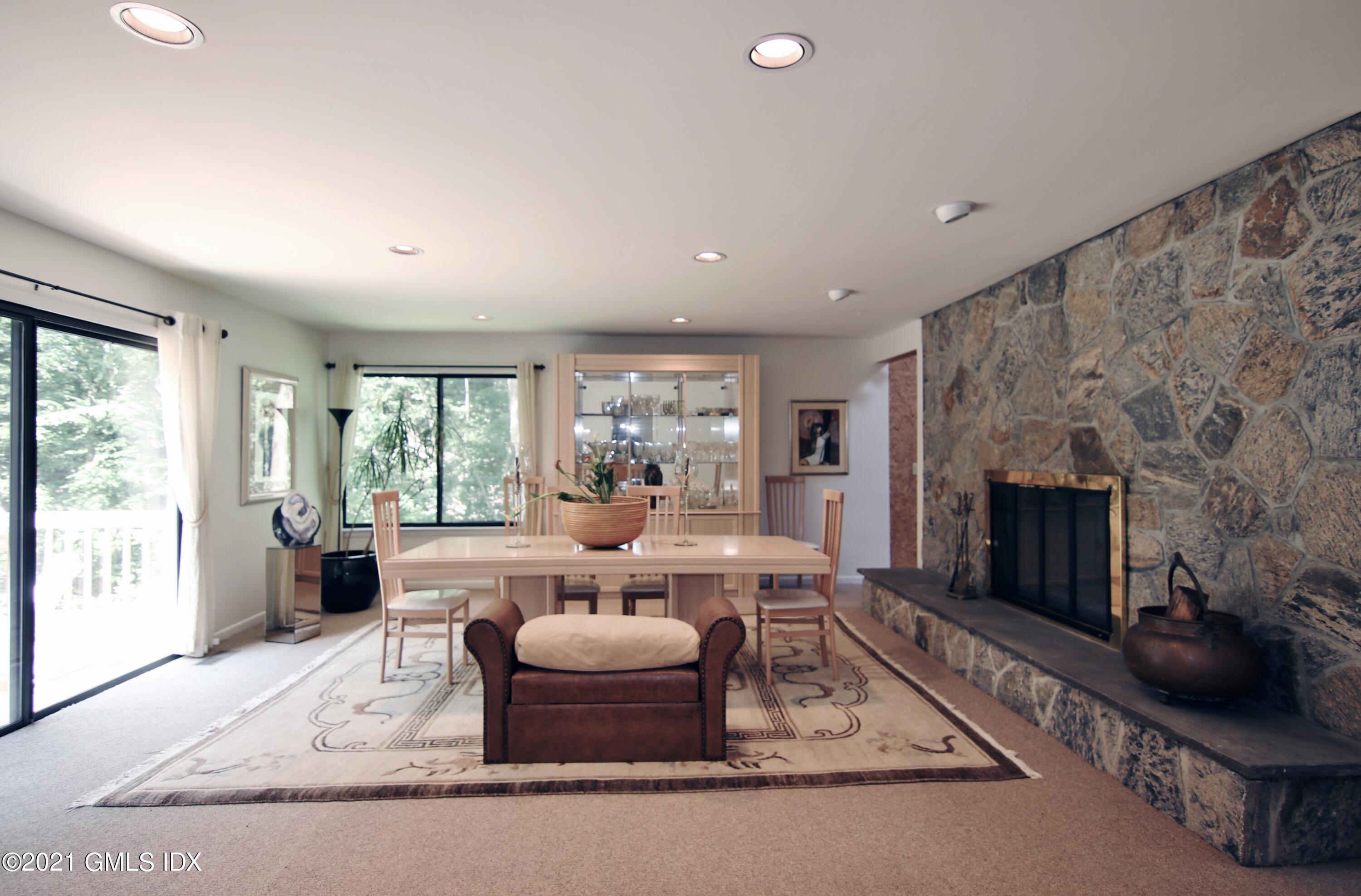106 Gun Club Road Stamford, CT 06903 - Photo 10 of 38 a living room with furniture fireplace and a fireplace