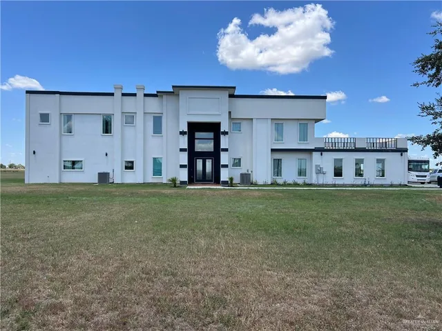 a view of a kitchen with a refrigerator and a fireplace