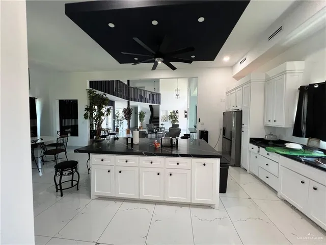 a kitchen with granite countertop a sink and cabinets