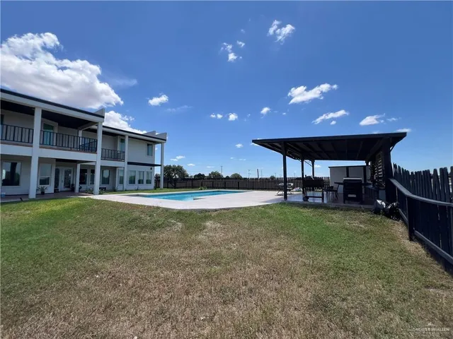 a view of a house with a backyard porch and sitting area