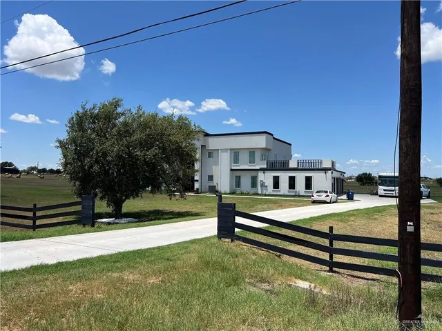 a view of a house with backyard and a slide