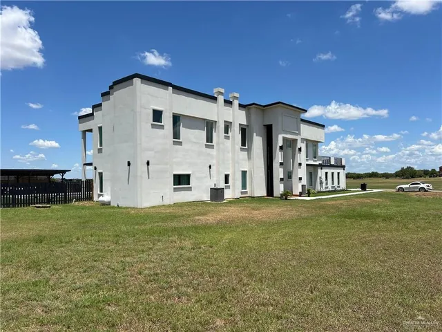 a big house with a big yard and more large trees