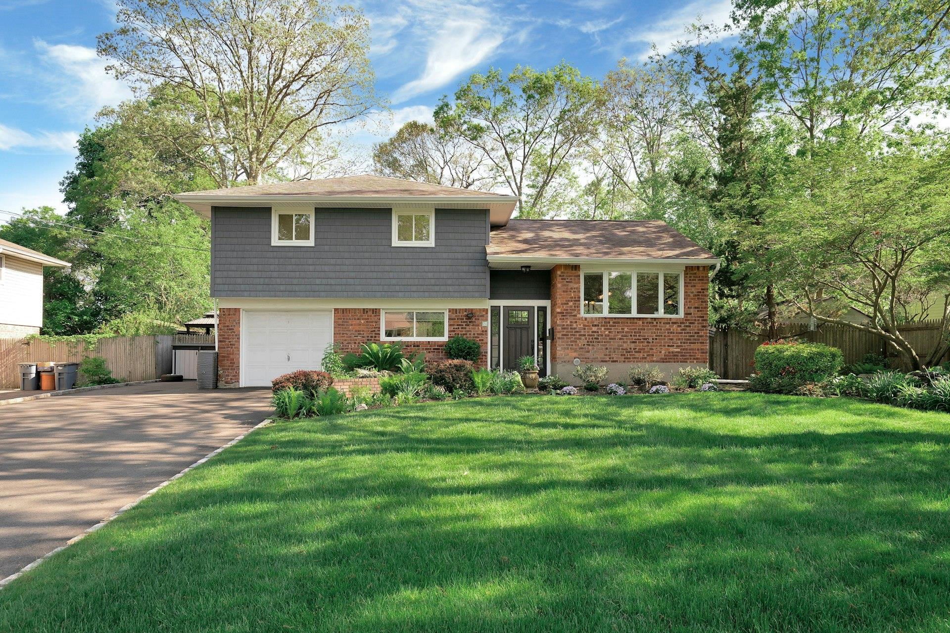 24 Harvard Lane Commack, NY 11725 - Photo 1 of 1 a front view of a house with a yard