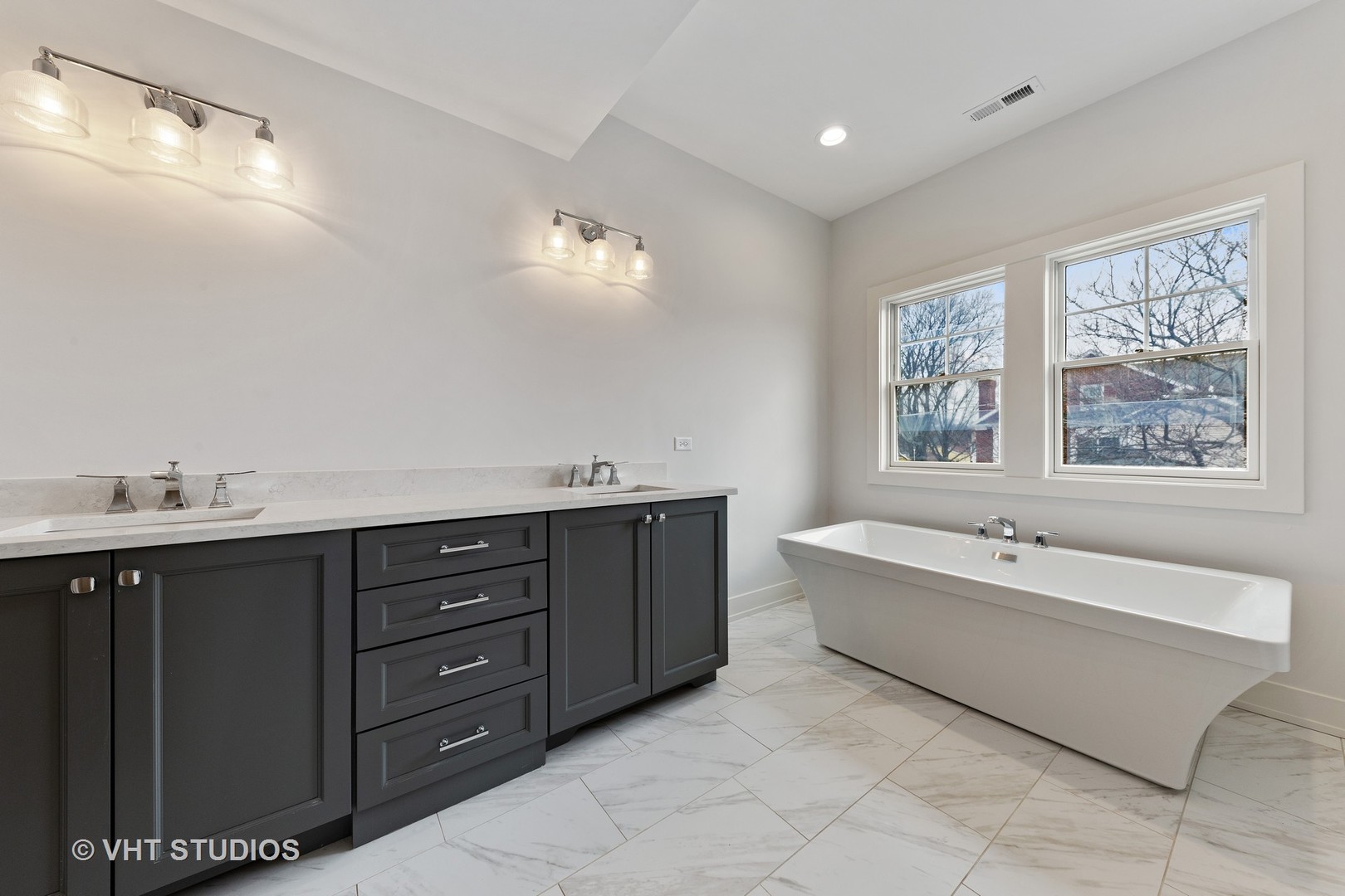 469 South Sunnyside Avenue Elmhurst, IL 60126 - Photo 20 of 37 a spacious bathroom with a tub sink double vanity and mirror